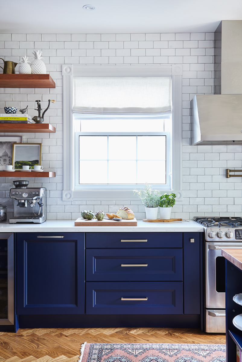 blue kitchen cabinets and white subway tile backsplash in interior designer's home downtown Burlington
