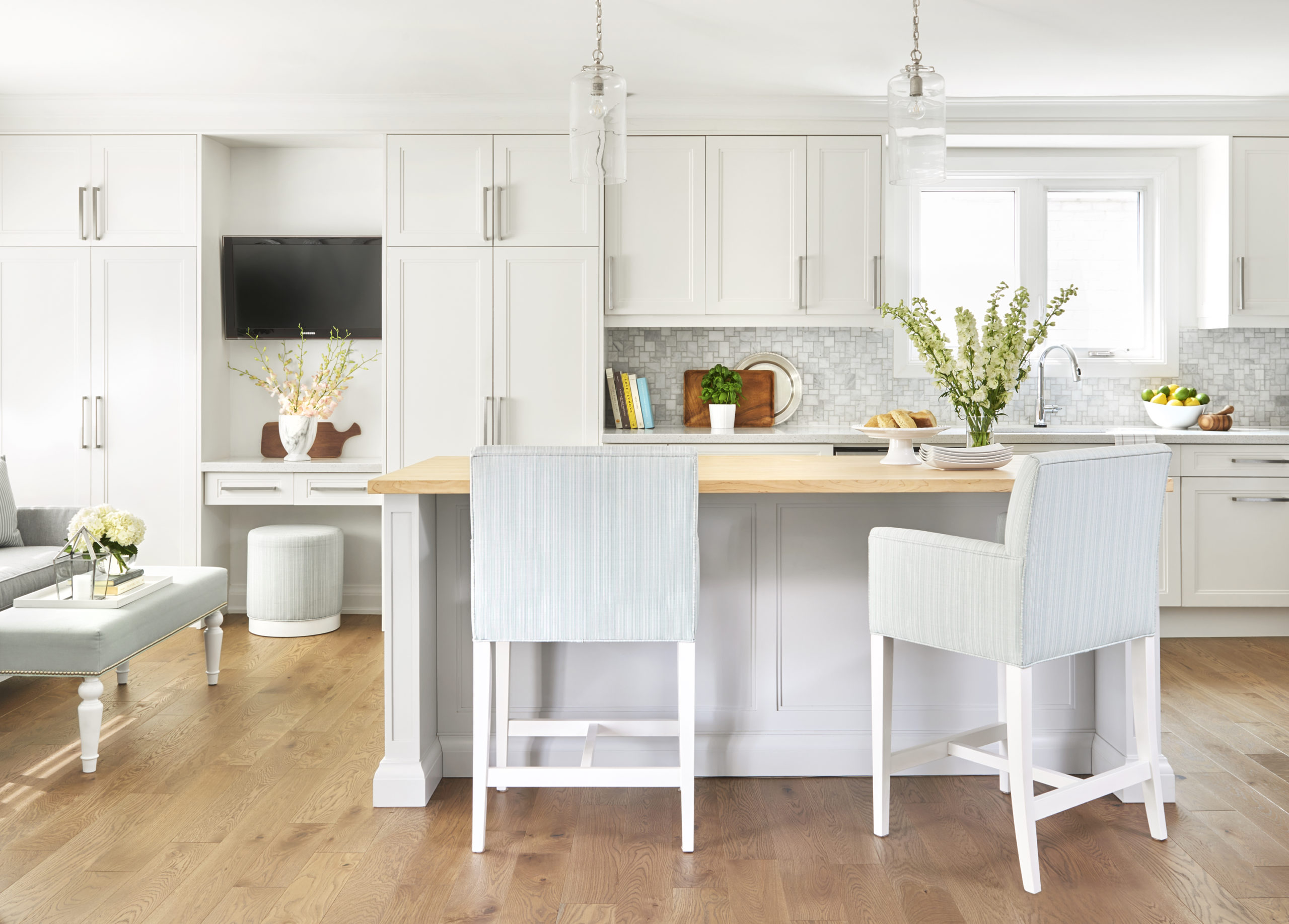 white kitchen with light grey island and butcher block counter top