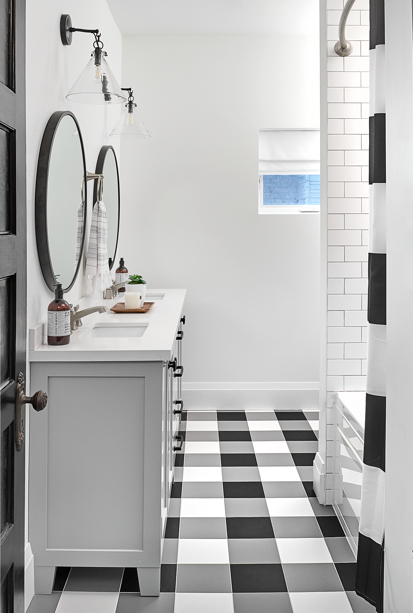 fun bathroom with checkered floor and custom grey vanity