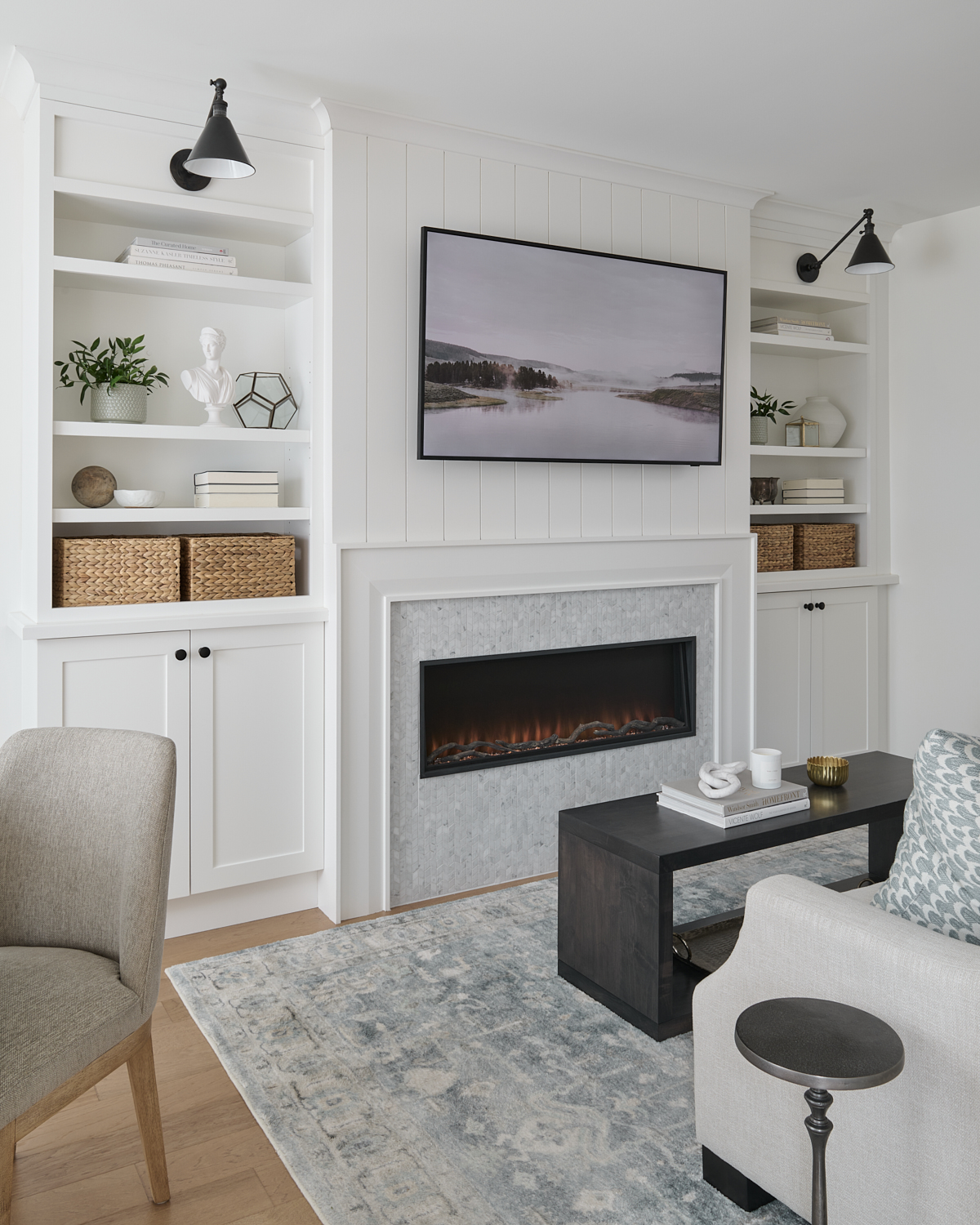 living room wall with fireplace and custom cabinetry styled beautifully with a mix of stylish accessories