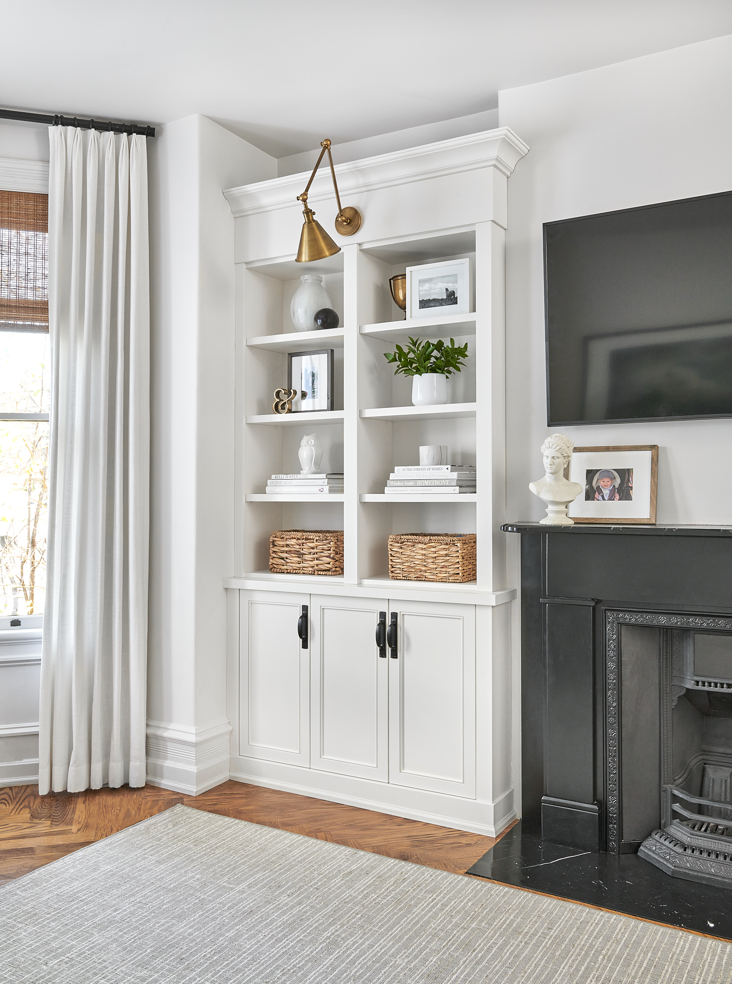 corner of living room with open shelving styled with beautiful accessories by staci edwards interior design