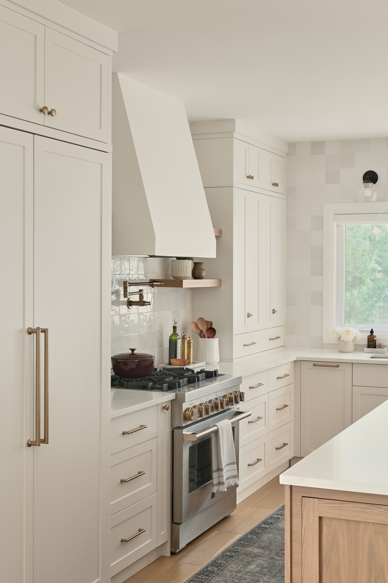 creamy white kitchen with zellige tile and gold hardware