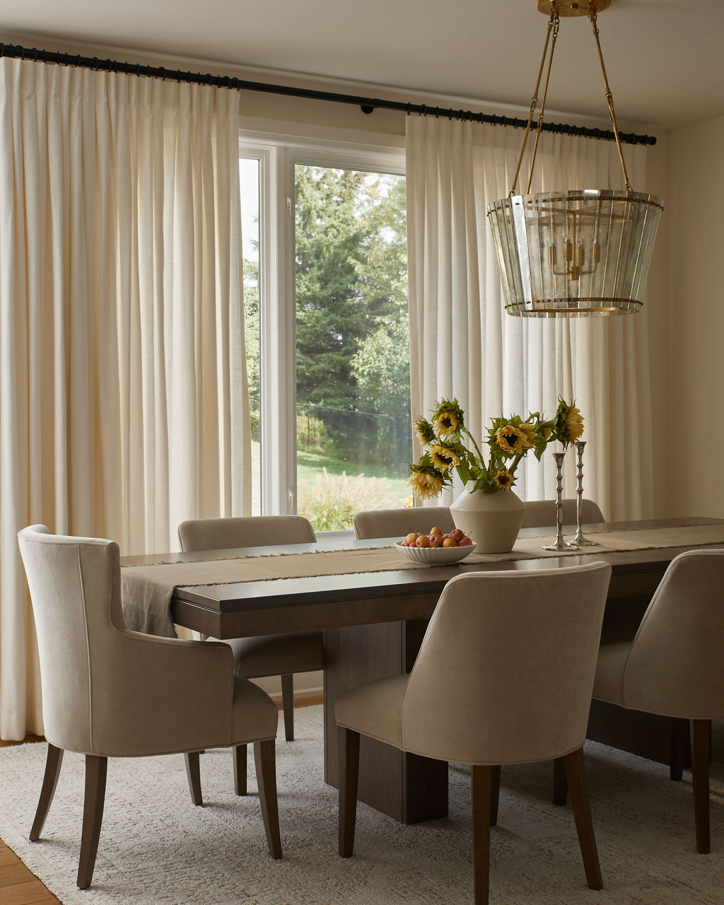 Light and warm dining room with timeless furnishings and open-concept layout at Hamilton interior design project